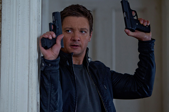 Image of Aaron Cross with two guns raised from The Bourne Legacy