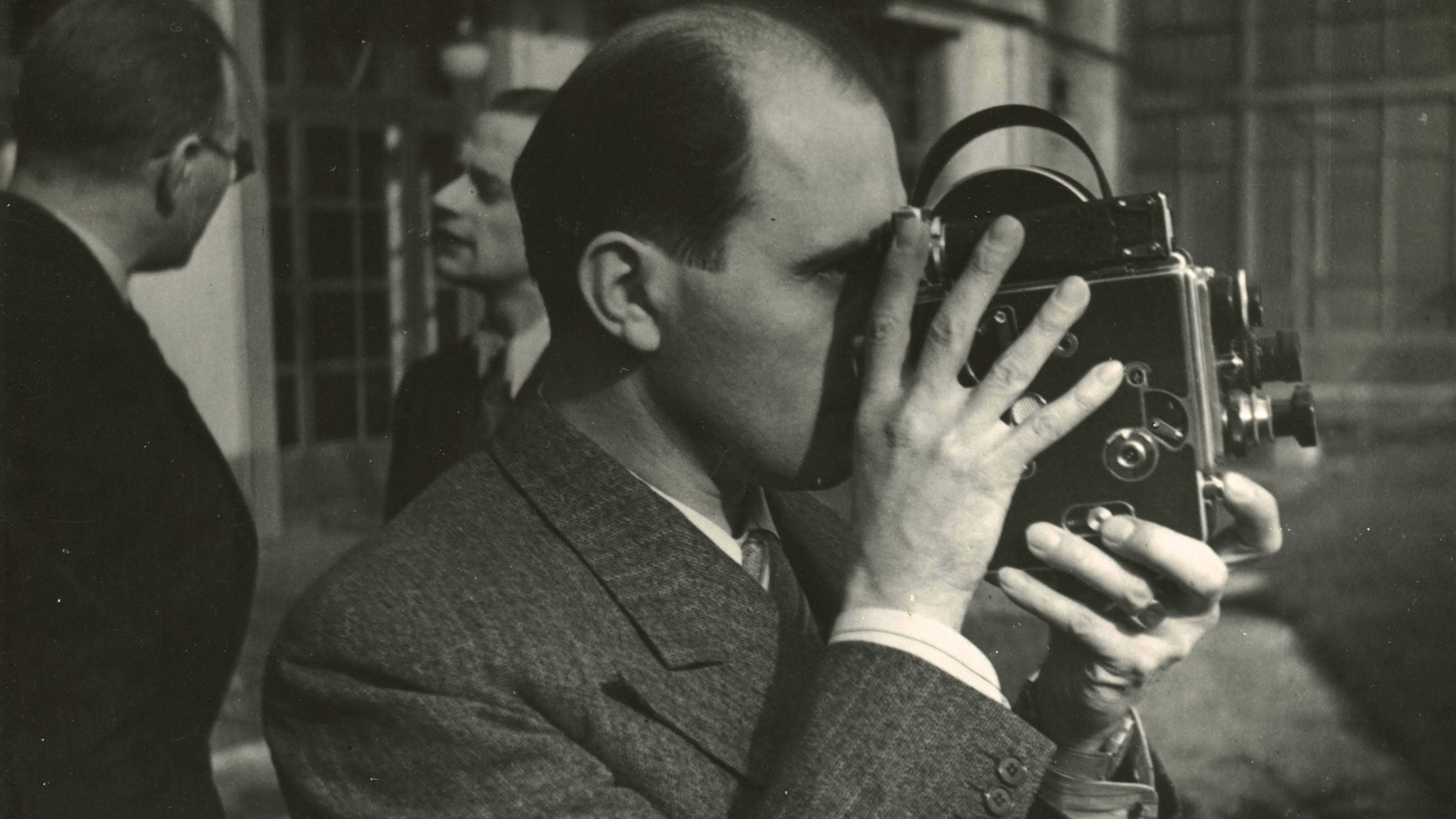 Bolex inventor Jacques Bolsey holds his invention.